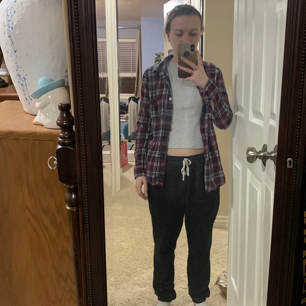 Red blue and white flannel with rcklss printed across the back on the bottom.
